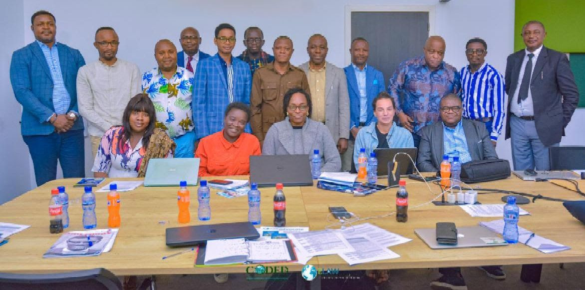 Mamadou Alpha Diallo (back row, 5th from left) joins ELAW Attorneys Érick Kassongo (back left) and Jennifer Castello (front row, 2nd from right) and colleagues at CODED.